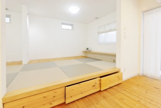 琉球畳がおしゃれな和室。札幌の高断熱・高気密化のリノベーションにより長期優良住宅先導モデルとして認められた、住宅の外気温に左右されない安定した室内環境を体感できるモデルハウス。パイン材の床に塗り壁とエコカラットの質感のあるアクセントウオール。アールデザインの玄関土間。市松に敷かれた琉球畳がおしゃれな和室。下は大容量の収納。レンジ横や出入り口の柱などにはアクセントにタイルを部分張り。施工はリビングワーク。