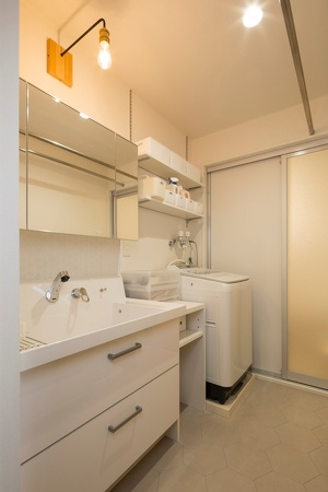 札幌・中古リノベーション・マンション。大空間のLDKにホームシアター機能を導入。配線は天井裏に。収納家具はすべて造作。キッチン腰壁は目隠しを兼ねたバル風のカウンター。広い浴室は戸建て用をカスタマイズして追い炊き機能も追加。扉の木目が美しいシステムキッチンは、ガスオーブンをビルトインしたタイプ。床と壁にヘキサゴン柄を採用した水回り。玄関には土間収納。大容量のウォークインクローゼット。RELIFE＊［リライフ］株式会社北王　リフォーム事業部のマンションリフォーム・リノベーション事例。