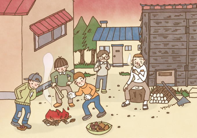 新聞紙に火をつけ、栗を焼く