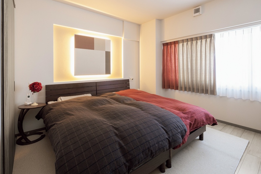 絵画風のエコカラットや間接照明がおしゃれな寝室。