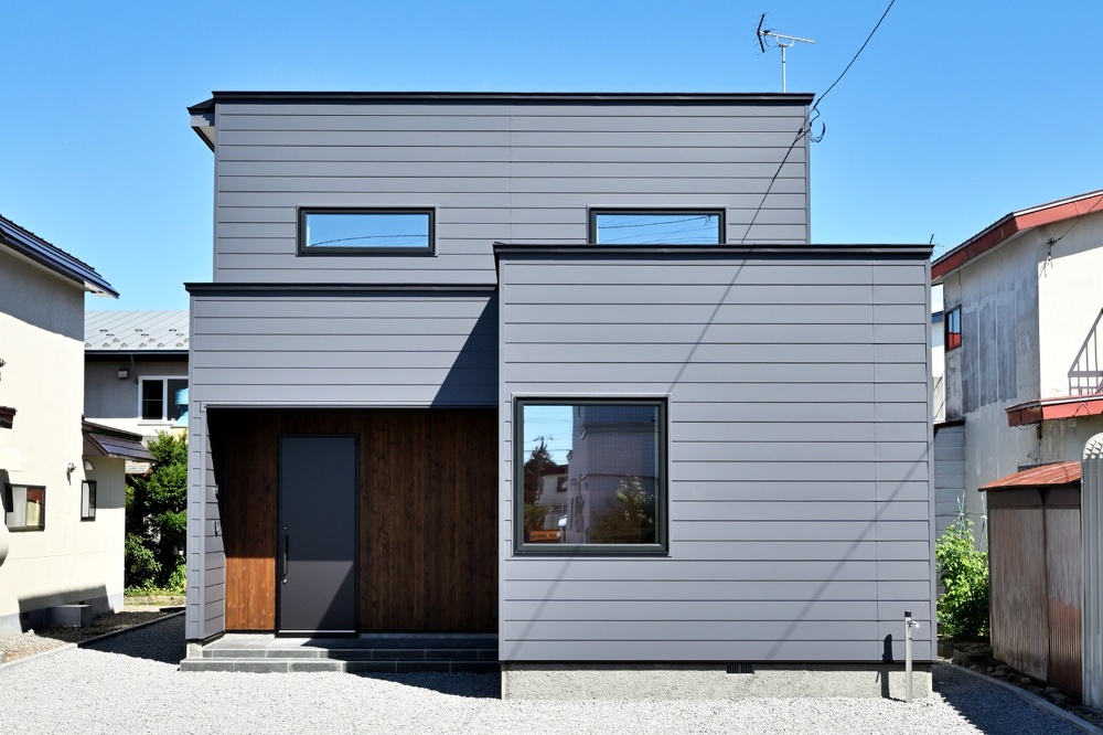 旭川｜戸建て｜モデルハウス(販売中)｜中古リノベーション施工事例｜石山工務店_平屋感覚＋ヴィンテージの『mature model』大人の空間_グレーのガルバリウム鋼板を使ったおしゃれな外観。玄関周りは杉板貼り